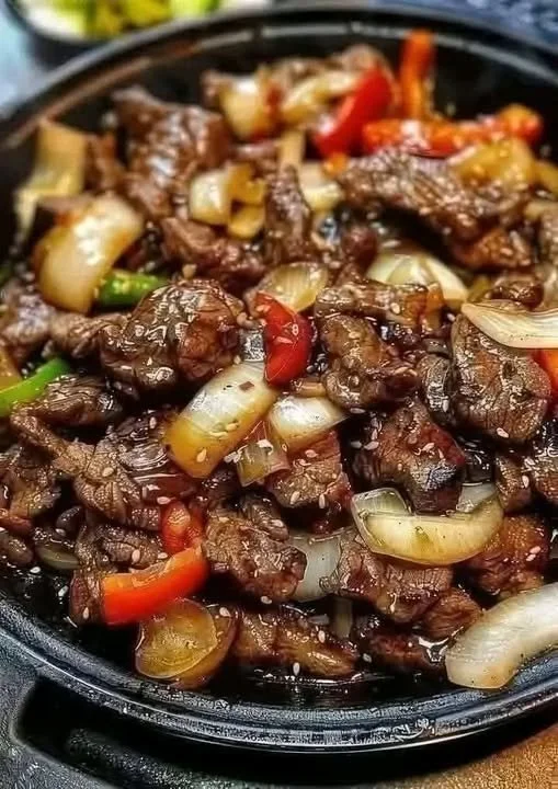 Sizzling Chinese pepper steak with onions served on a plate