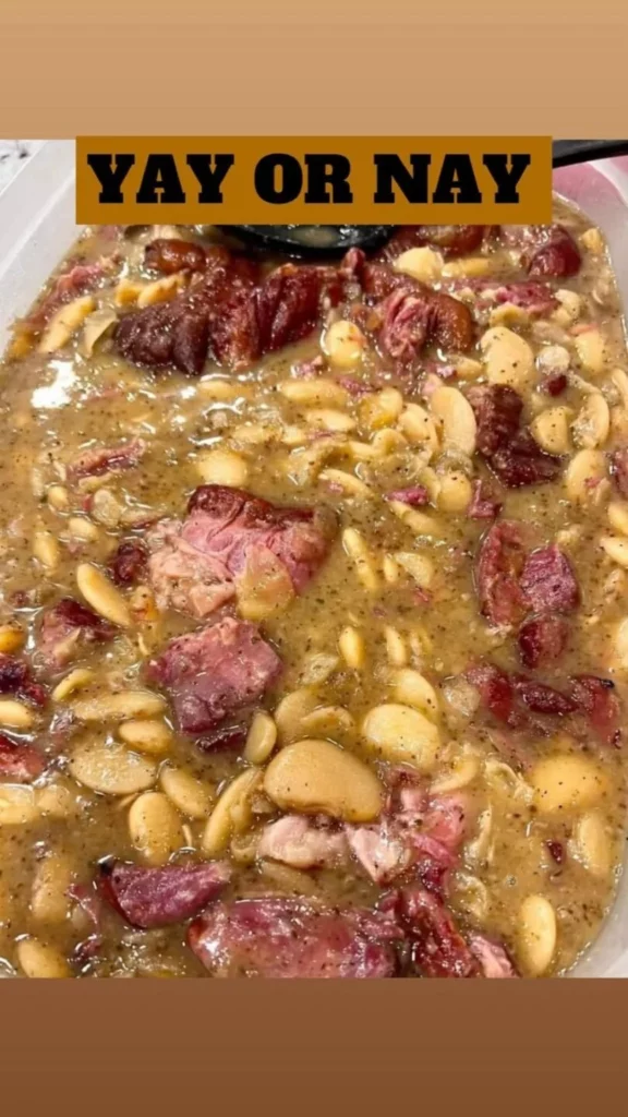 Bowl of white bean and smoked ham hock soup garnished with herbs