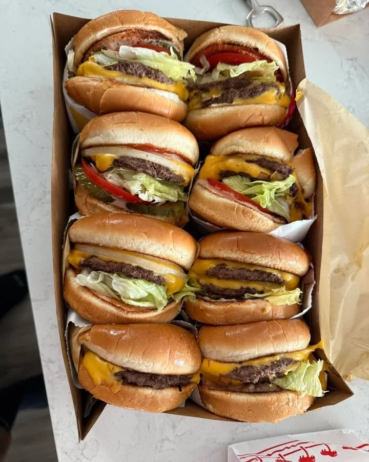 A festive Christmas scene featuring a decorated tree and a delicious burger
