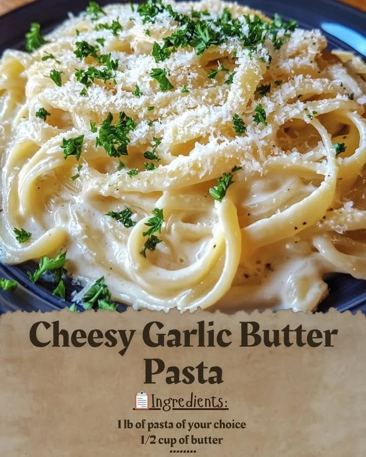 Cheesy garlic butter pasta topped with herbs and cheese in a bowl