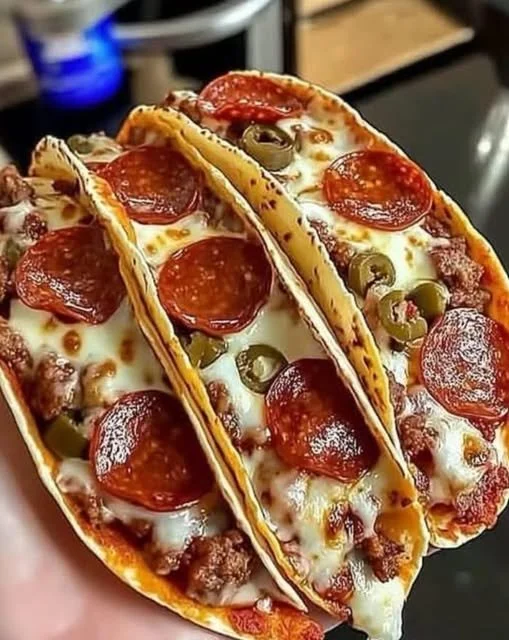 Cheesy Pepperoni Pizza Tacos served on a plate with toppings
