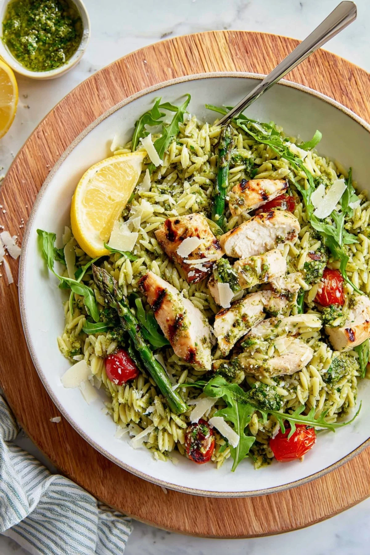 Chicken Pesto Orzo Salad with colorful vegetables and fresh basil