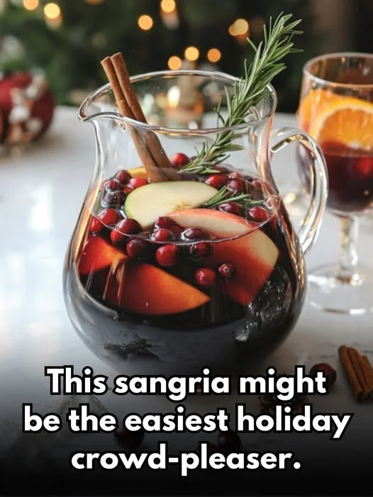 Festive Christmas Sangria in a glass with seasonal fruit and spices