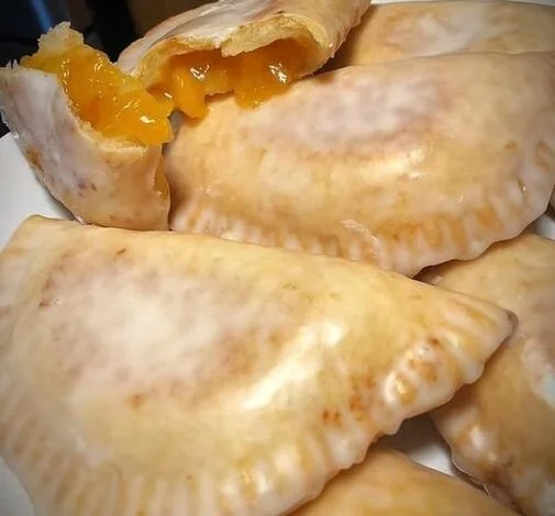 Delicious homemade fried apple and peach pies served on a plate