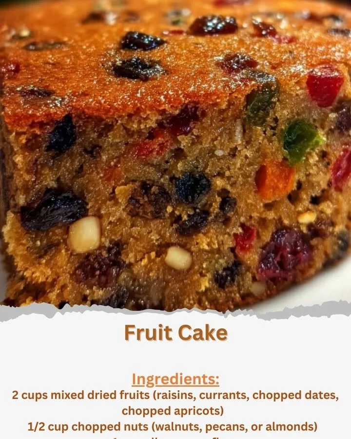 Deliciously decorated fruit cake with colorful fruits and nuts on a festive table.