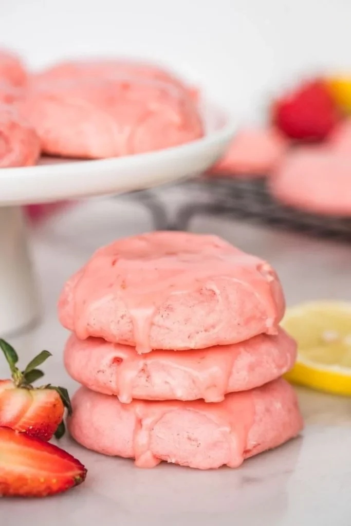 Glazed strawberry cake mix cookies on a plate, showcasing their delicious texture and glaze
