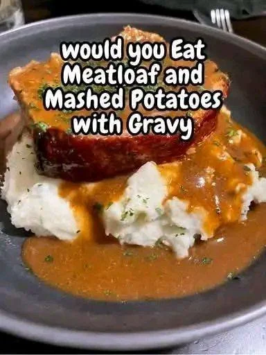 Delicious meatloaf served with mashed potatoes and gravy on a plate