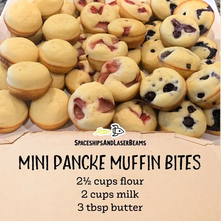 Plate of fluffy mini pancakes with syrup and berries