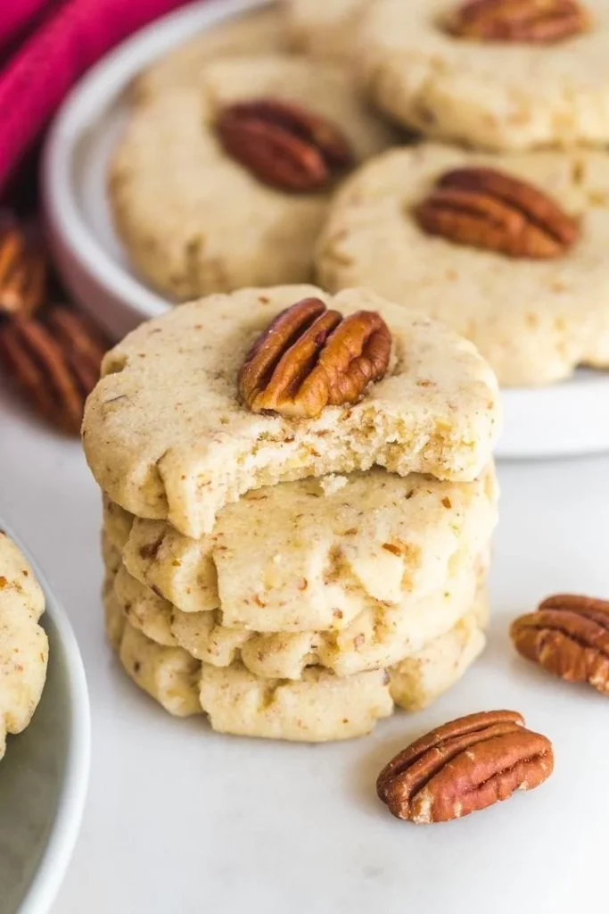 Delicious Pecan Sandies cookies on a rustic wooden table