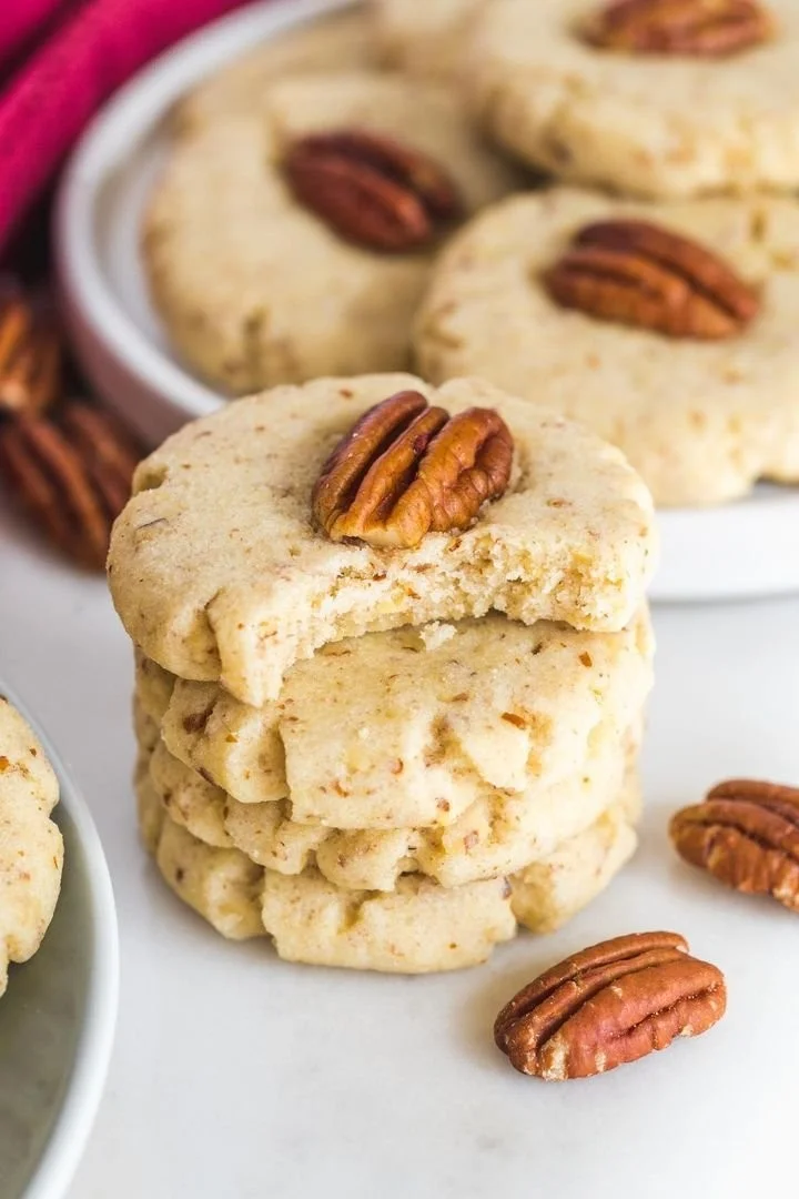Delicious Pecan Sandies cookies on a rustic wooden table