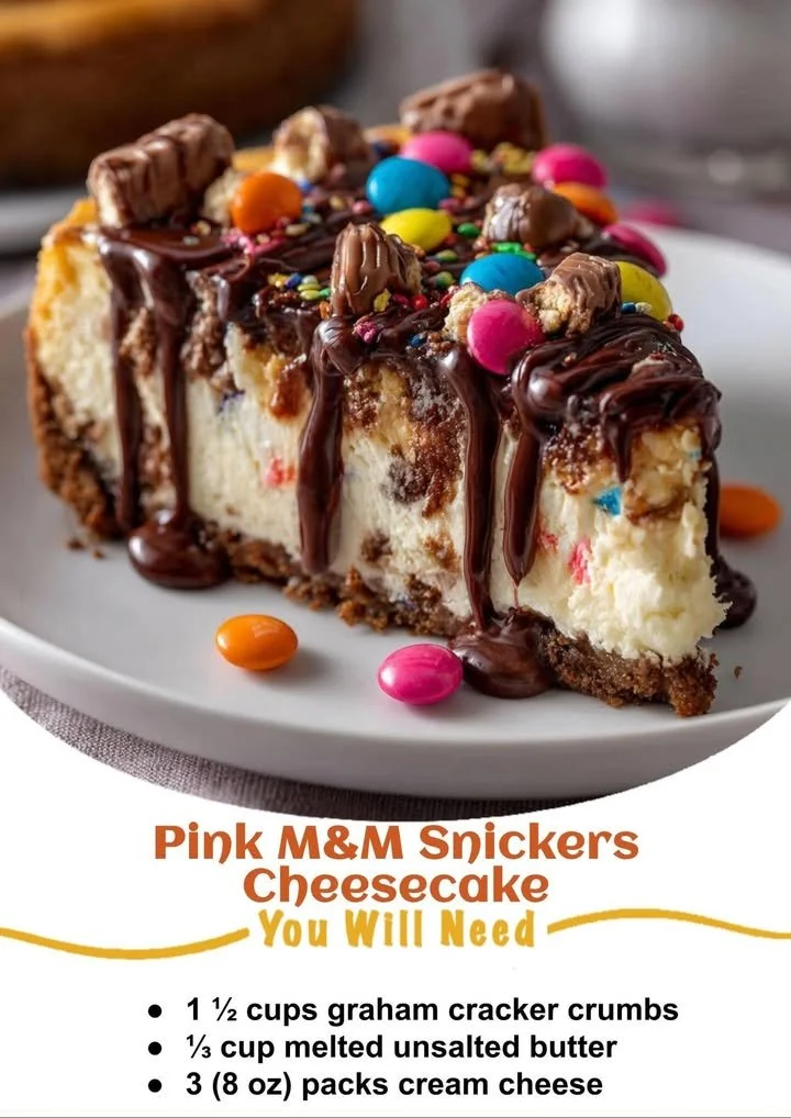 Slice of Pink M&M Snickers Cheesecake with colorful toppings