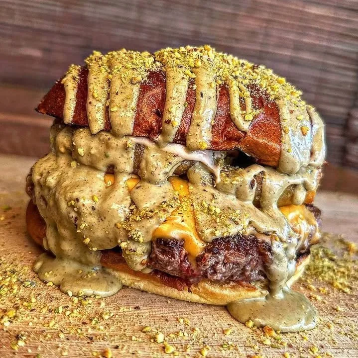 A delicious pistachio burger served with fresh toppings and a vibrant bun.