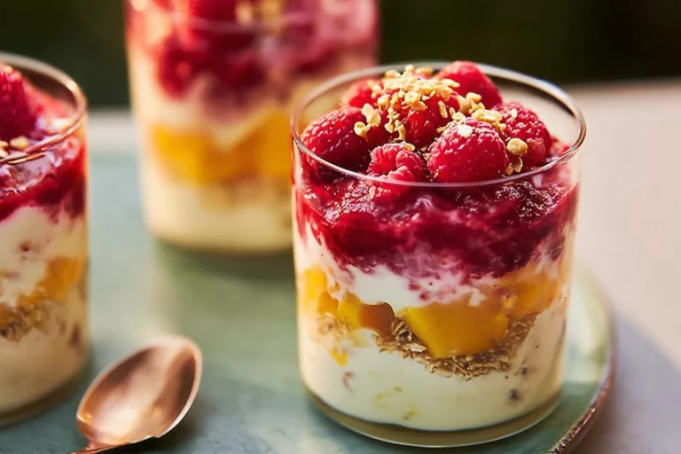 Raspberry and Mango Yogurt Parfait layered with fruits and granola