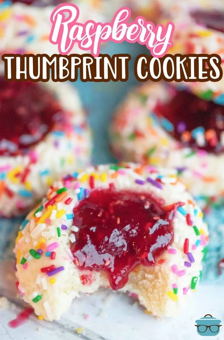 Delicious homemade raspberry thumbprint cookies on a cooling rack.
