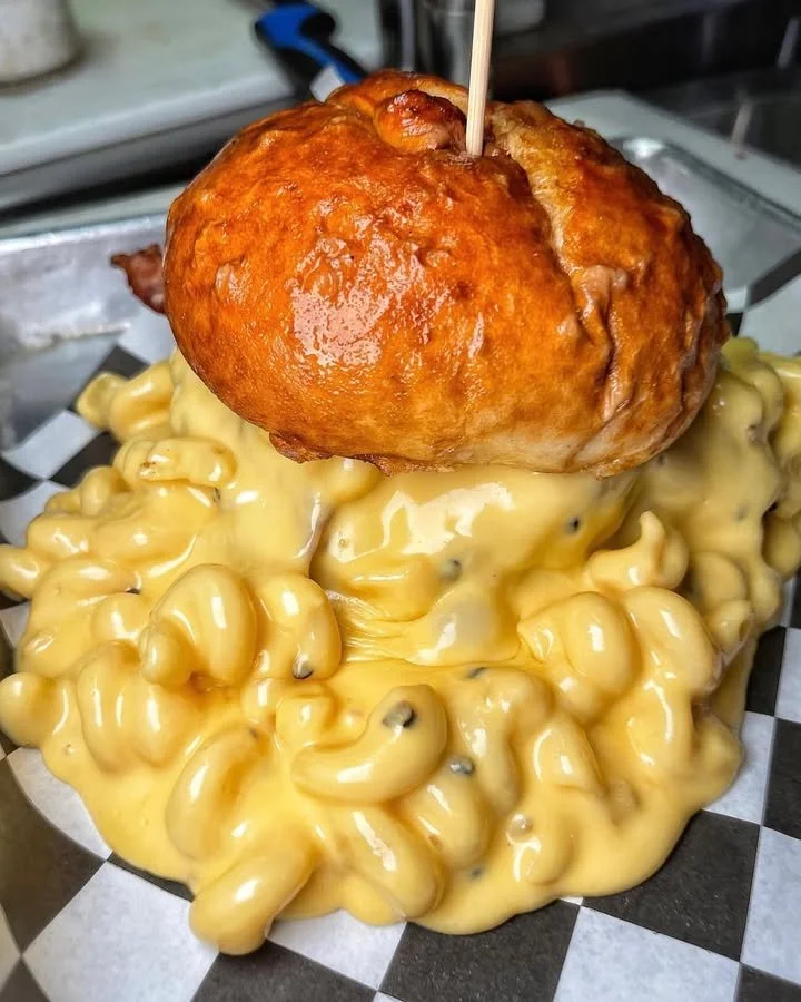 Pizza slice topped with extra cheese, showcasing gooey cheese stretch.